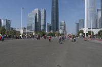 a city skyline with many tall buildings and people walking on a walkway along it, with a person in a stroller and one man walking away