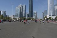 a city skyline with many tall buildings and people walking on a walkway along it, with a person in a stroller and one man walking away