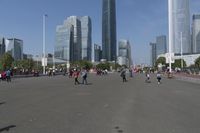 a city skyline with many tall buildings and people walking on a walkway along it, with a person in a stroller and one man walking away
