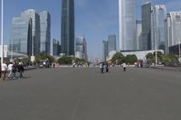 a city skyline with many tall buildings and people walking on a walkway along it, with a person in a stroller and one man walking away