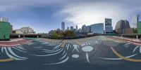 the reflection is shown on the paved parking lot near buildings in a city skylined area