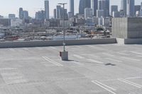 a view of a parking lot overlooking a city skyline, and a red and yellow fire hydrant