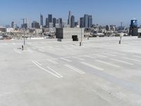 a view of a parking lot overlooking a city skyline, and a red and yellow fire hydrant