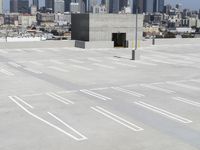 a view of a parking lot overlooking a city skyline, and a red and yellow fire hydrant