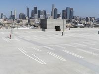 a view of a parking lot overlooking a city skyline, and a red and yellow fire hydrant