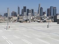 a view of a parking lot overlooking a city skyline, and a red and yellow fire hydrant