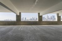 a parking space with a view to a city skyline from two buildings'atriumes