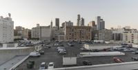 the view of buildings and street from a rooftop parking lot, near a cityscape