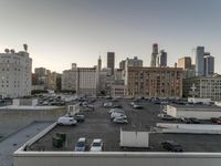 the view of buildings and street from a rooftop parking lot, near a cityscape