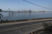 a view of the water and city skyline across a wide bay, with a bridge on both sides