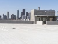 a yellow fire hydrant sitting in a parking lot next to a city skyline with tall buildings