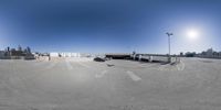 an empty parking lot surrounded by parking lots and city skylines in the background area