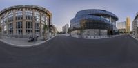 this 360 - angle shot was taken using the tilt camera of a street corner and city skyscrapers