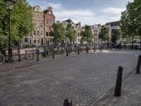 a city square with parked bicycle's in the center of a park area in holland