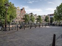 a city square with parked bicycle's in the center of a park area in holland