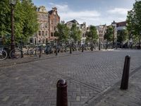 a city square with parked bicycle's in the center of a park area in holland