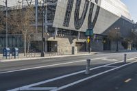 a city street has an abstract architecture on it's side and a bike path