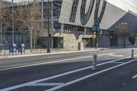 a city street has an abstract architecture on it's side and a bike path