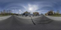 a view of a street through a fisheye lens on a skateboard ramp while parked