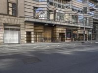 the city street has empty, no cars on it, as seen through the closed glass door