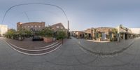 this image shows a fish eye view of the city from the sidewalk in an angle