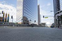 a city street has multiple lines and empty traffic lanes in the middle of it with buildings along side and street signs