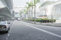 an image of the city street that has some buildings near by it and trees on either side