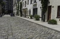 a brick street with cars parked next to it in the city area of the city