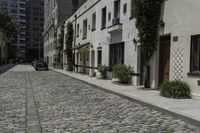 a brick street with cars parked next to it in the city area of the city