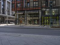 a view of a city street corner, with bicycles in front of it and a building