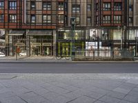 a view of a city street corner, with bicycles in front of it and a building