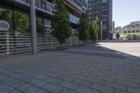 this is a city street with people walking around it on a sunny day outside of the building