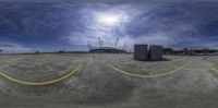 a wide angle shot of the ground and the buildings in the background with a blue sky