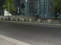 a city street in the evening with a traffic light on it's side and an empty road to the right of the building