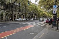 a city street in france with no traffic stopped at one end and red stripes painted on the other side