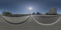 a 360 - view of a city street next to high rise buildings, with a street light