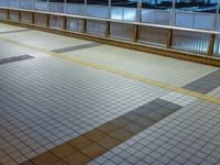 people standing on a subway platform with many buildings in the background at night light in tokyo