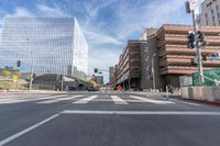 a city street with several tall buildings in the background, a man is driving on his motorcycle