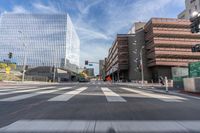 a city street with several tall buildings in the background, a man is driving on his motorcycle