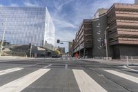 a city street with several tall buildings in the background, a man is driving on his motorcycle