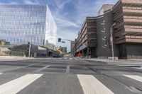 a city street with several tall buildings in the background, a man is driving on his motorcycle