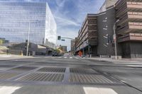 a city street with several tall buildings in the background, a man is driving on his motorcycle