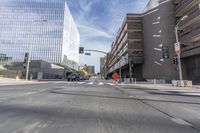 a city street with several tall buildings in the background, a man is driving on his motorcycle