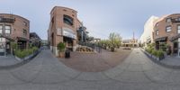 a view of a street with multiple buildings in it of the camera lens panoramicly