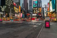 a city street with tall buildings and a bus stop sign that says times square in front