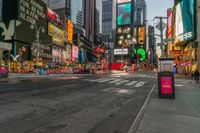 a city street with tall buildings and a bus stop sign that says times square in front