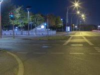 street lights at night in a city with a single lane on either side of the road