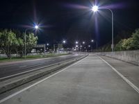 a city street at night with all the lights on and empty roads that lead to nowhere