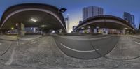 a fisheye lens on a city street at night, showing the camera's angle