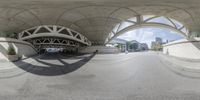 a reflection of a person walking in an empty street with an arch overhead it is the picture of a circular space